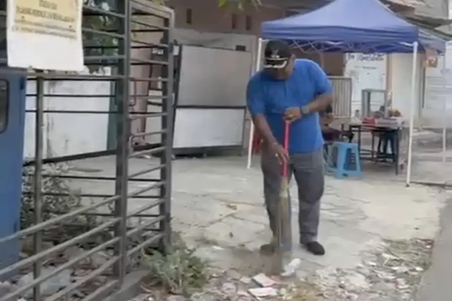 Lurah Beji, Samsu Sadikin, saat membersihkan jalan saat Operasi Bersih (Opsih) di wilayah RW 02, RW 03, dan RW 13, Jumat (31/07/26). (Sumber foto: Tangkapan layar Instagram Kelurahan Beji)