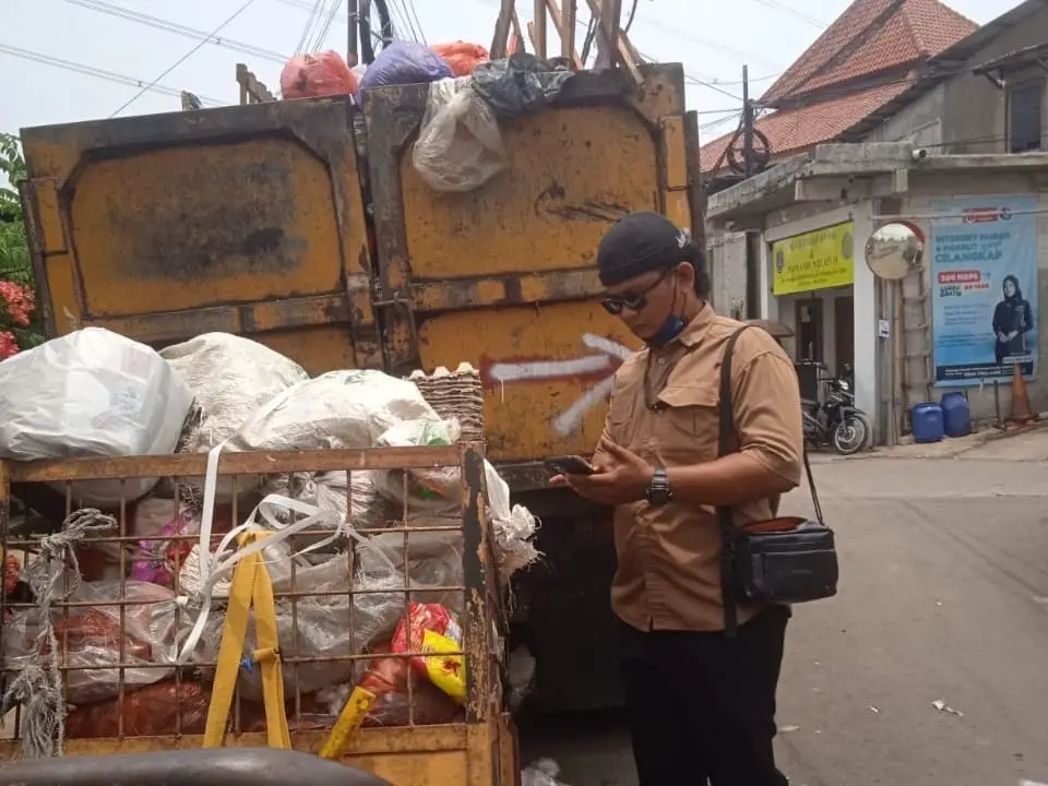 Petugas DLHK Kota Depok merespons aduan masyarakat mengenai gerobak sampah yang terparkir di depan hunian warga di kawasan Kelurahan Cilangkap, Kecamatan Tapos. (Foto: Dok. DLHK Kota Depok)